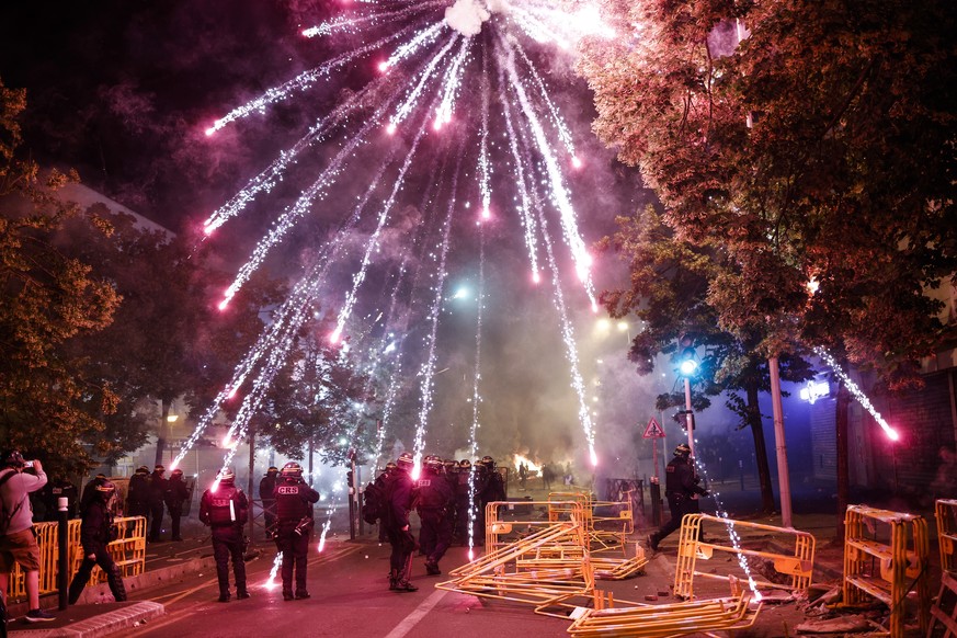 epa10716123 Protesters throw fireworks at riot police during clashes in Nanterre, near Paris, France, 29 June 2023. Violence broke out after police fatally shot a 17-year-old during a traffic stop in  ...