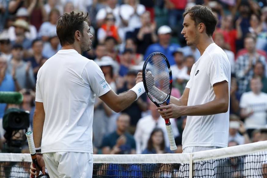 Stan Wawrinka of Switzerland, left, and Daniil Medvedev of Russia shake hands after their Men's Singles Match on the opening day at the Wimbledon Tennis Championships in London Monday, July 3, 2017.(K ...