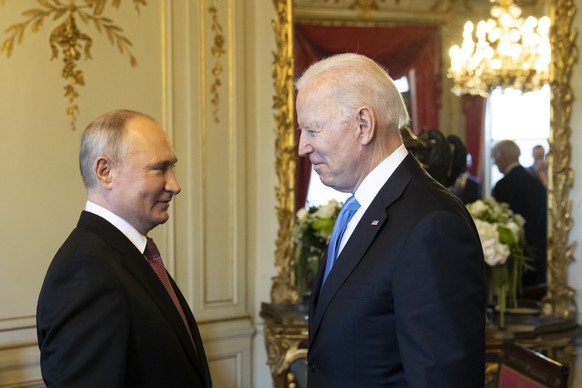 Russian president Vladimir Putin, left, talks to US president Joe Biden after their arrival at the villa La Grange, during the US - Russia summit in Geneva, Switzerland, Wednesday, June 16, 2021. (Swi ...