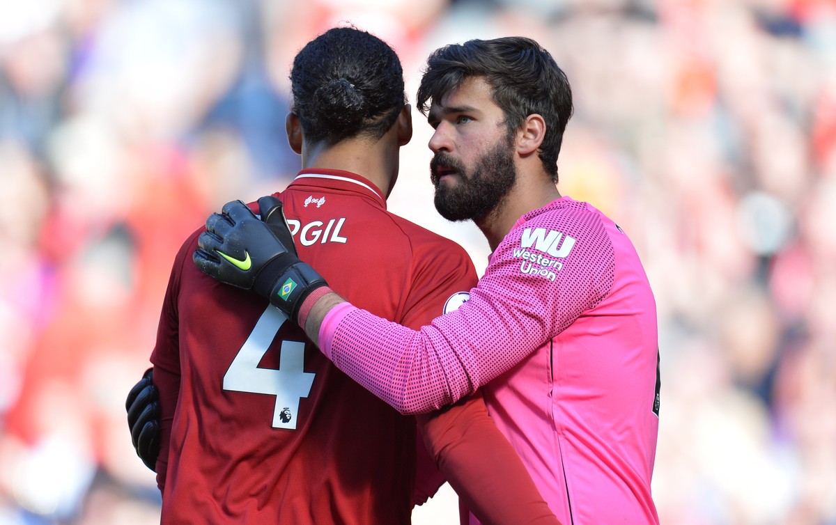 epa07564829 Liverpool's Virgil Van Dijk (L) and Alisson Becker (R) react after winning the English Premier League match between Liverpool FC and Wolverhampton Wanderers FC at Anfield, Liverpool,  ...
