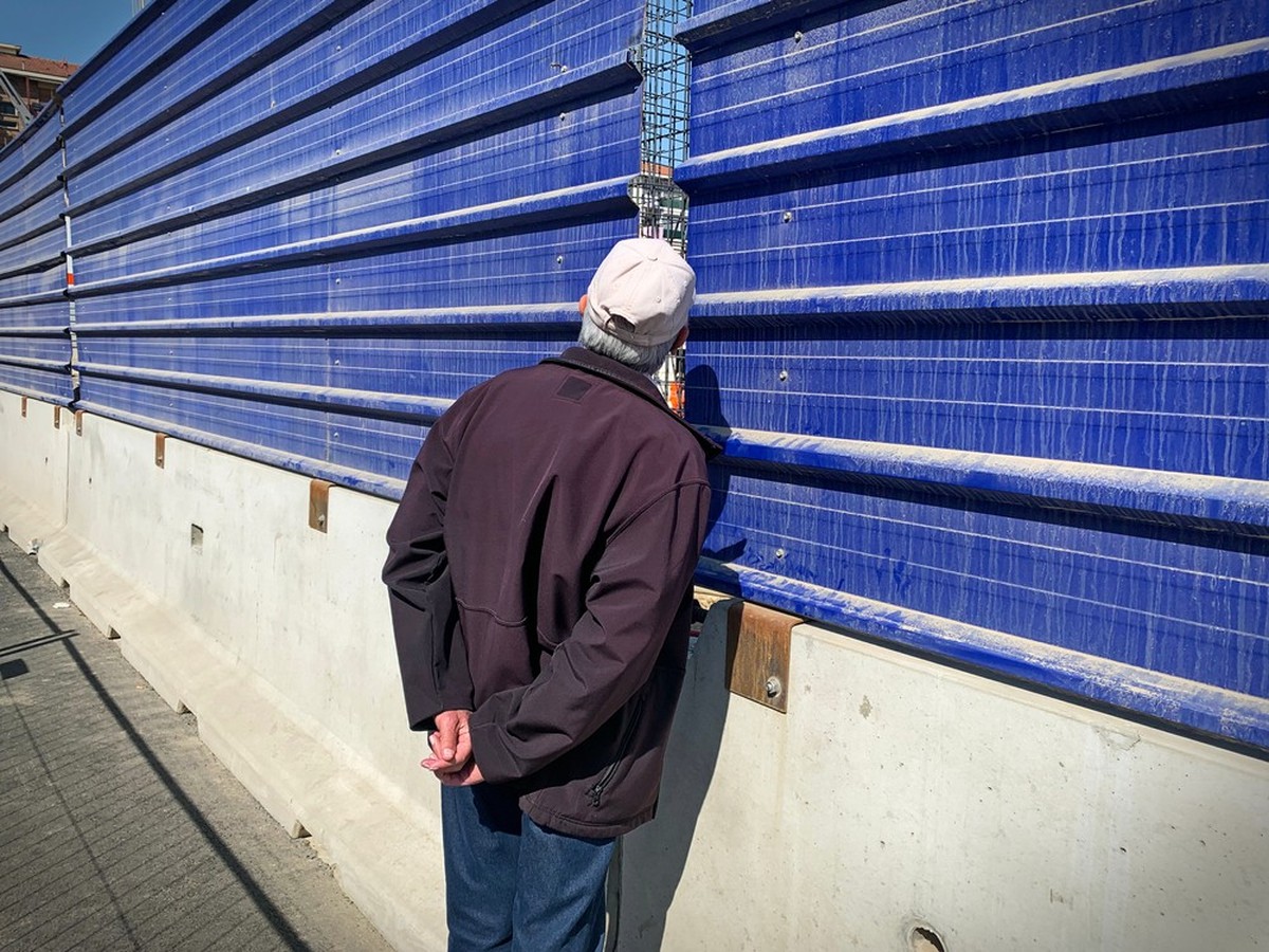 Umarell: Man of retirement age who pass the time watching construction sites— stereotypically with hands clasped behind their back. Turin Italy - March 2021