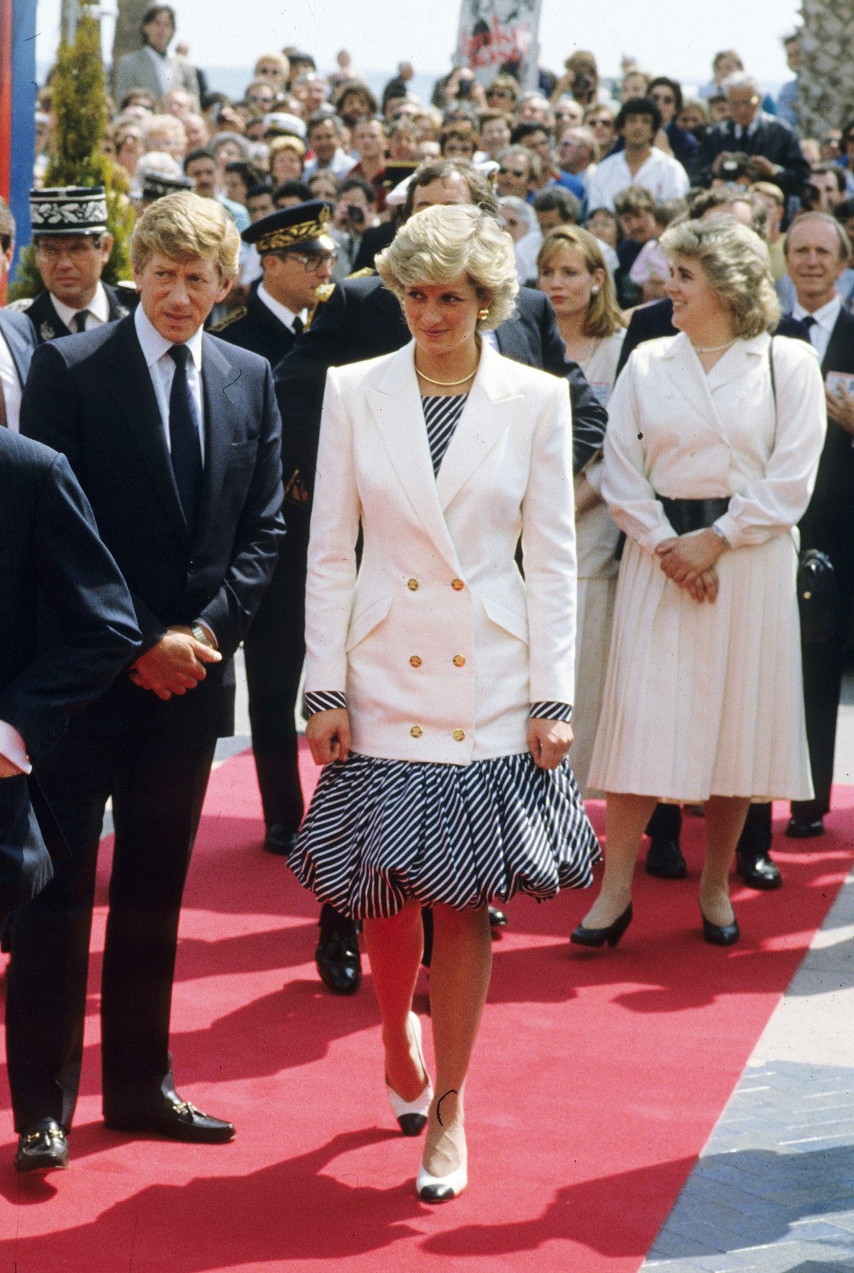 CANNES, FRANCE - MAY 15: Diana, Princess of Wales, wearing a navy and white striped dress with a puffball skirt designed by Catherine Walker and a double breasted white blazer, attends the Cannes Film ...
