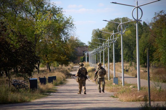 Two Russian Army soldiers patrol an area in the center of the Russia-controlled city of Kurakhove, Donetsk region, Ukraine, Saturday, Sept. 27, 2025. (AP Photo)
Russia Ukraine