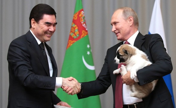 11th October 2017 - Sochi, Russia - Russian President Vladimir Putin holds an Alabai puppy gifted to him by Turkmen President Gurbanguly Berdymukhamedov, left, prior to their meeting at the Bocharov Ruchei...