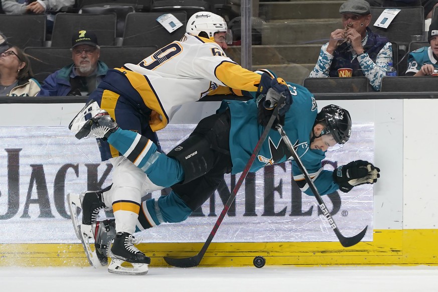 San Jose Sharks left wing Matt Nieto, bottom, is knocked to the ice by Nashville Predators defenseman Roman Josi during the first period of an NHL hockey game in San Jose, Calif., Saturday, March 5, 2 ...