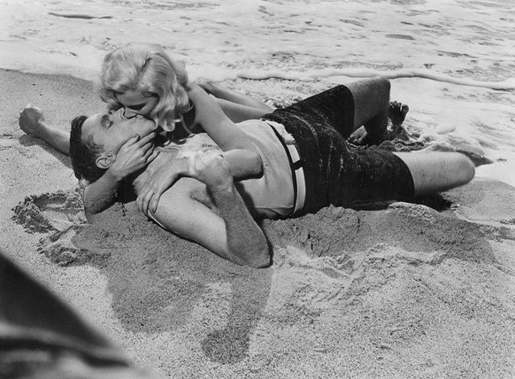 13th August 1955: Dolores Rosedale and Tom Ewell (1909 - 1994) embrace on a beach in a scene from Billy Wilder&#039;s romantic comedy &#039;The Seven Year Itch&#039;. The scene is a parody of the famo ...