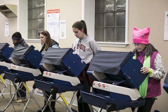 A group of women early vote in the midterm elections after the Women&#039;s March Chicago on Saturday, Oct. 13, 2018 in Chicago. Thousands of people marched through downtown Chicago to express their d ...