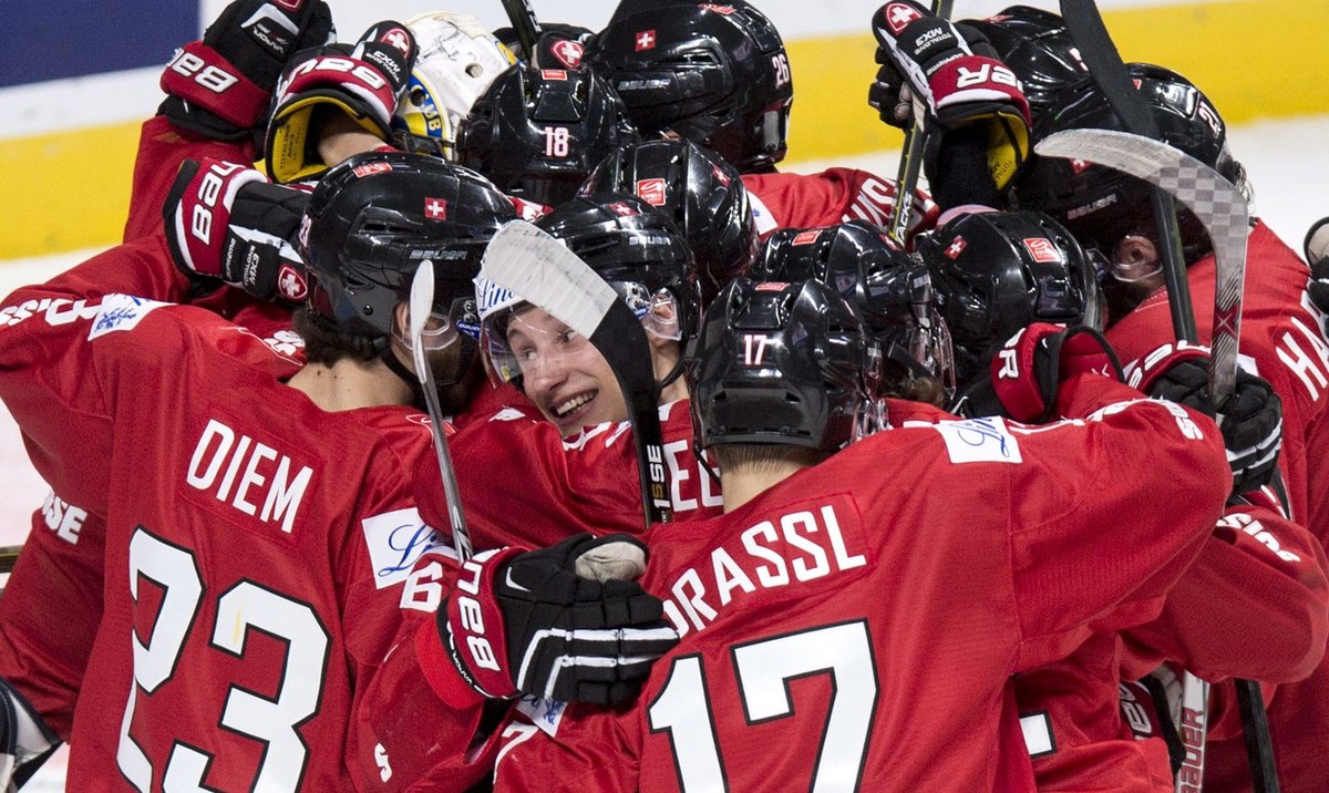 Switzerland's Loic In Albon, center, is surrounded by teammates as they celebrate their 5-4 victory over Denmark in the shootout of a World Junior hockey tournament game Friday, Dec. 30, 2016 in  ...