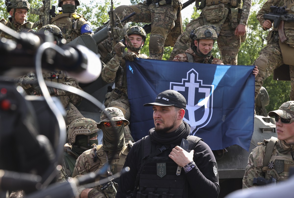 epa10650659 A 'Russian Volunteer Corps' member nicknamed 'White Rex' (C) attends a meeting with the media not far from the Ukraine-Russia border in Kharkiv's area, northeaster ...