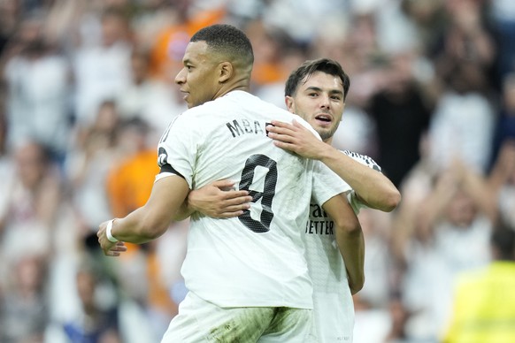 Real Madrid's Kylian Mbappe, left, celebrates after scoring the opening goal against Real Sociedad during a Spanish La Liga soccer match at Santiago Bernabeu stadium in Madrid, Saturday, May 24, ...