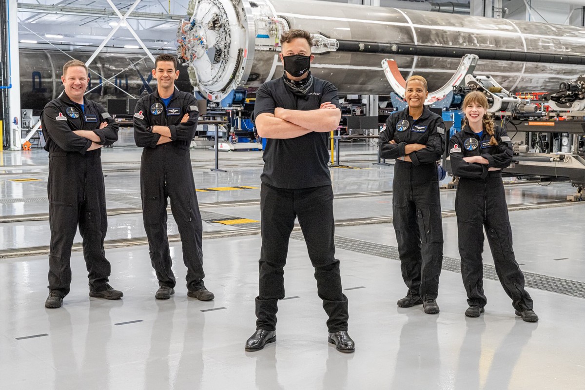 In this photo provided by Inspiration4, Elon Musk, front center, poses with the all-amateur crew before departure to Launch Complex 39A for a launch into space, Wednesday, Sept. 15, 2021, at Kennedy S ...