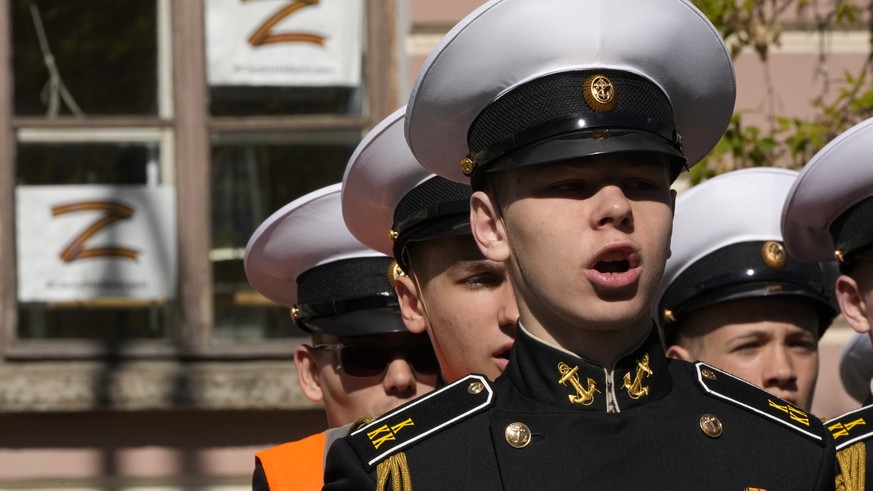 Navy school cadets attend celebrations marking 318th anniversary of the city of Kronstadt, outside St. Petersburg, Russia, Saturday, May 21, 2022, with sheets depicting letter Z, which has become a sy ...
