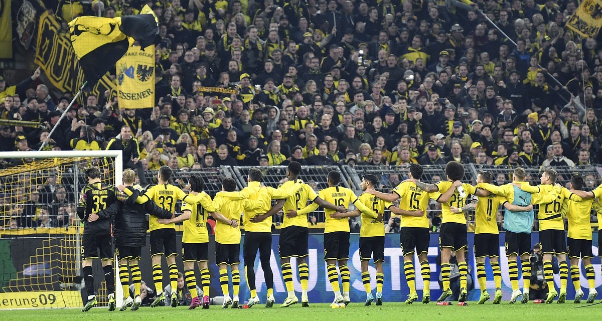 Dortmund's players celebrates with fans after winning the German Bundesliga soccer match between Borussia Dortmund and Borussia Moenchengladbach in Dortmund, Germany, Saturday Oct. 19, 2019. (AP  ...