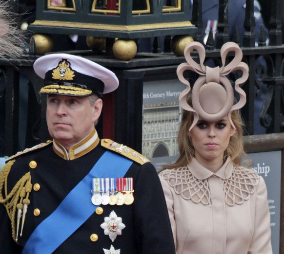 FILE - In this April, 29, 2011 file photo, Britain&#039;s Prince Andrew, center, and his daughters Britain&#039;s Princess Eugenie, left, and Britain&#039;s Princess Beatrice leave Westminster Abbey a ...