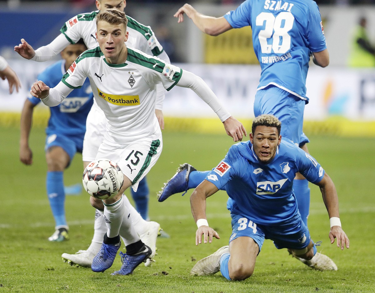 Hoffenheim's Joelinton, right, and Moenchengladbach's Louis Jordan Beyer challenge for the ball during a German Bundesliga soccer match between TSG 1899 Hoffenheim and Borussia Moenchengladb ...