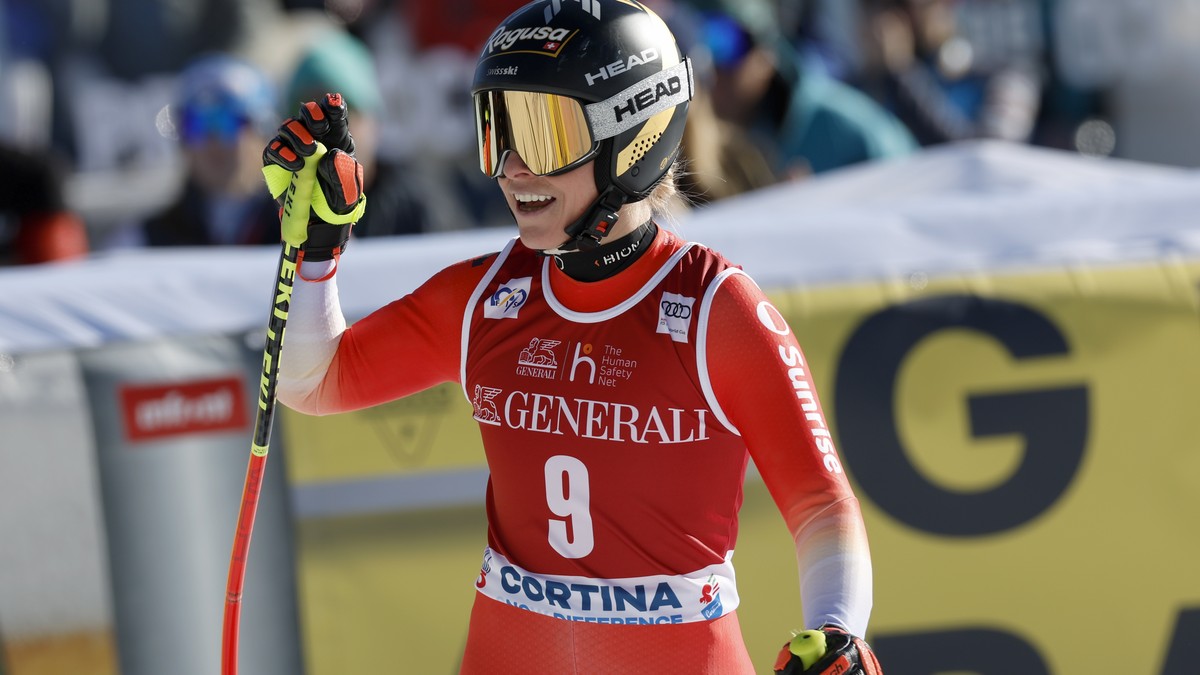 Switzerland's Lara Gut Behrami celebrates at the finish area of an alpine ski, women's World Cup downhill race, in Cortina d'Ampezzo, Italy, Friday, Jan. 26, 2024. (AP Photo/Alessandro  ...