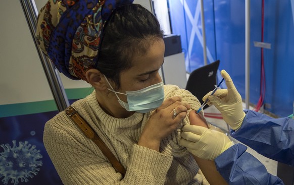 epa09031407 Israeli woman is vaccinated against COVID-19 in the Medical Center in Jerusalem, Israel, 23 February 2021. Israel has so far vaccinated over four and a half million of its around nine mill ...