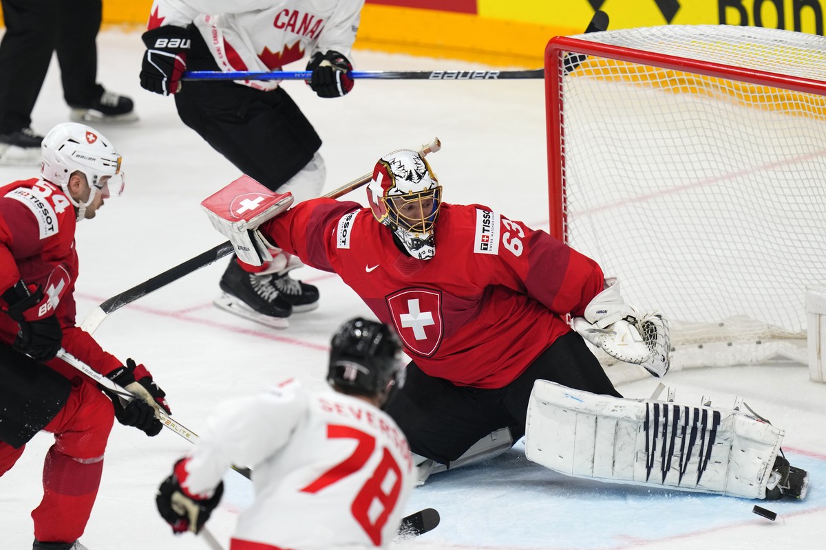 Switzerland's goalkeeper Leonardo Genoni makes a save during the preliminary round match between Canada and Switzerland at the Ice Hockey World Championships in Prague, Czech Republic, Sunday, Ma ...