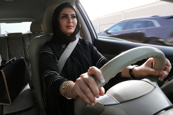 epa06836500 Huda al-Badri, 30, poses behind a steering wheel as women are alowed to drive for the first time through the streets of the capita, Riyadh, Saudi Arabia, in the early morning hours of 24 J ...