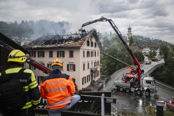 epa13182439 Firefighters try to put out a fire at a building with a restaurant and apartments in Thusis in eastern Switzerland, 21 August 2026. Five people are reported missing following a major fire, ...