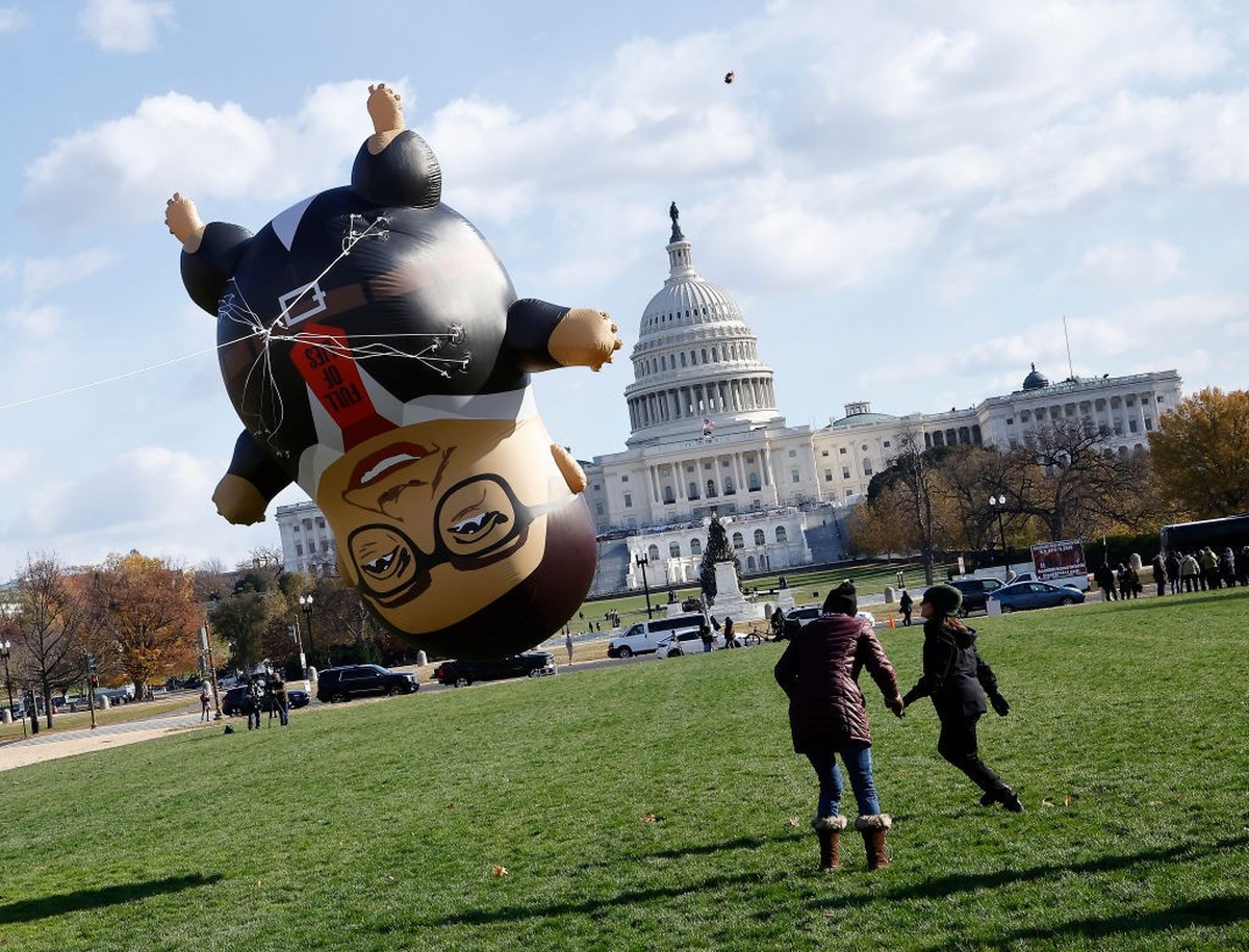 WASHINGTON, DC - NOVEMBER 28: MoveOn debuts a 15-foot-tall inflatable of Rep. George Santos (R-NY) ahead of a possible vote to expel Santos from Congress on Capitol Hill on November 28, 2023 in Washin ...