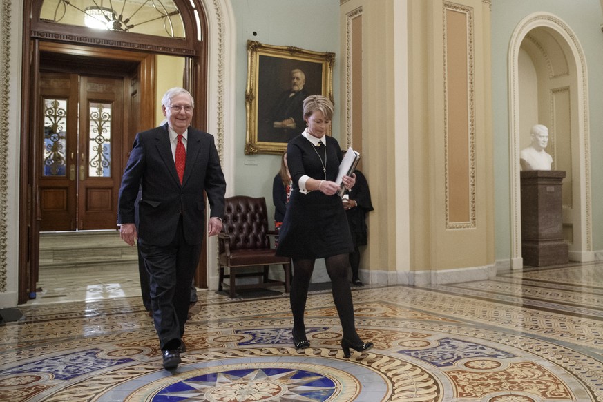 epa08149757 Senate Majority Leader Mitch McConnell (L) leaves the Senate floor following the first full day of the impeachment trial at the US Capitol in Washington, DC, 21 January 2020. The first ful ...