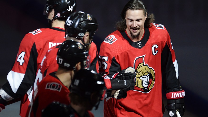 Injured Ottawa Senators defenseman Erik Karlsson (65) bumps gloves with teammates during player introductions for the team&#039;s NHL hockey game against the Washington Capitals in Ottawa, Ontario, Th ...