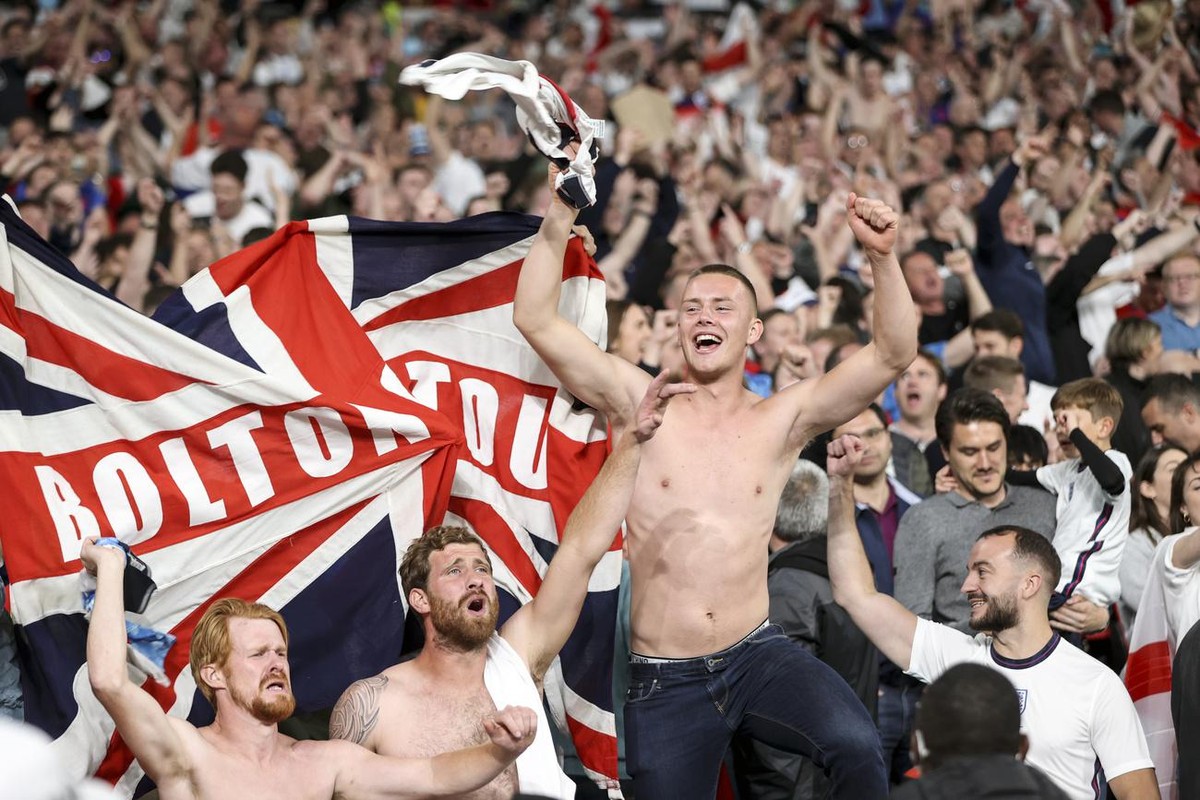 England fans celebrate after Harry Kane scored his side's 2nd goal during the Euro 2020 soccer championship semifinal match between England and Denmark at Wembley stadium in London, Wednesday, Ju ...