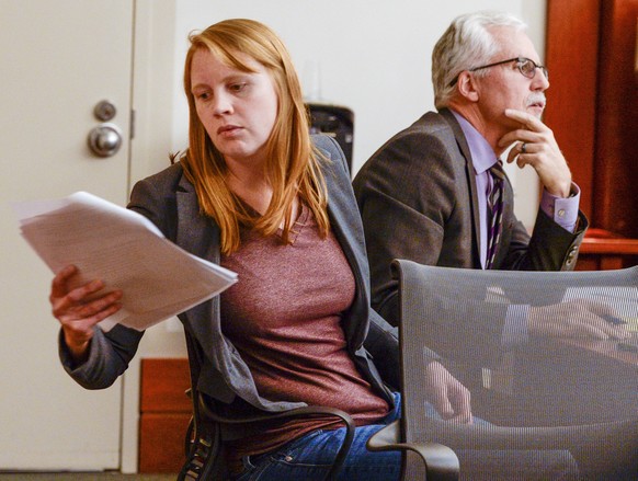 FILE - In this Nov. 19, 2019, file photo, Tilli Buchanan, left, reads a document in court as she sits with Randy Richards, right, her attorney, during deliberations in a case where Buchanan was charge ...