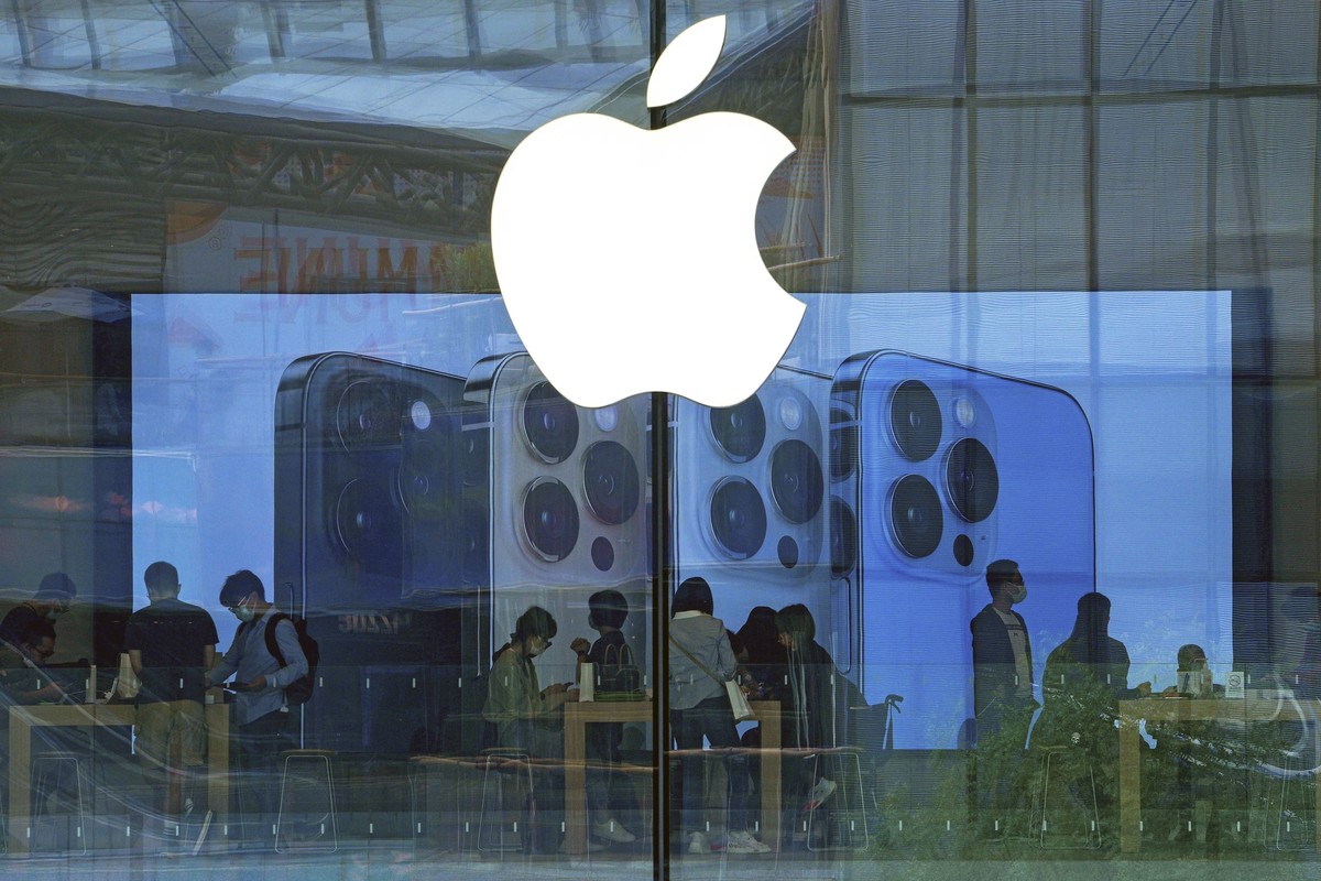 FILE - People try out iPhone products at an Apple Store in Beijing, Sept. 28, 2021. A federal judge on Wednesday questioned whether Apple has set up a gauntlet of exasperating hurdles to discourage th ...
