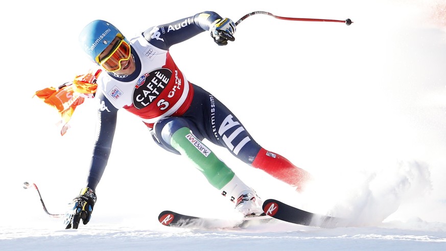 Christof Innerhofer of Italy speeds down with a part of a gate that remained entrapped in his race glasses during the men's downhill race at the Alpine Skiing World Cup in Santa Caterina Valfurva, nor ...