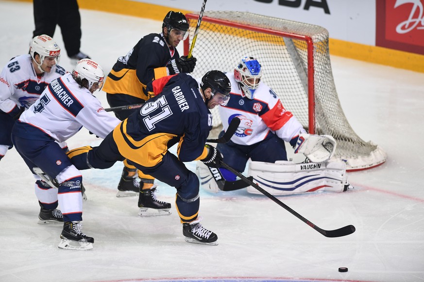 Zurich&#039;s Morris Trachsler, Severin Blindenbacher, Lugano’s Maxim Lapierre, Ryan Gardner and Zurich&#039;s goalkeeper Lukas Flueeler, from left, fight for the puck during a Champions Hockey League ...