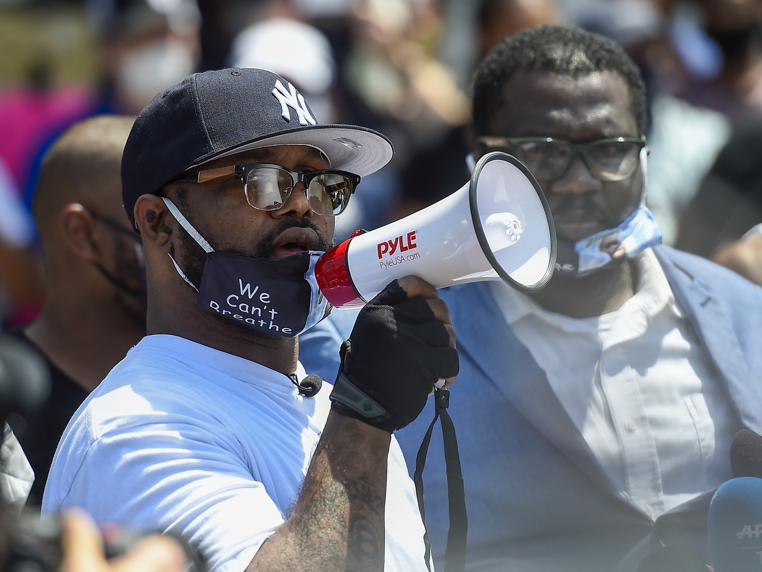 epa08459003 George Floyd&#039;s brother Terrence Floyd (white t-shirt) addresses the protesters as they gather near the intersection of 38th and Chicago in front of the Cup Foods at the spot where Geo ...