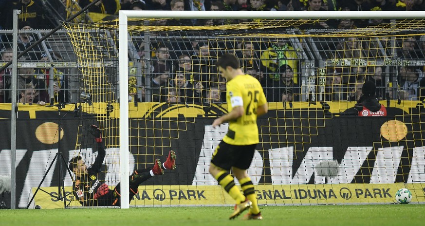 Dortmund goalkeeper Roman Buerki falls in his goal after Freiburg scored for the second time during the German Bundesliga soccer match between Borussia Dortmund and SC Freiburg in Dortmund, Germany, S ...