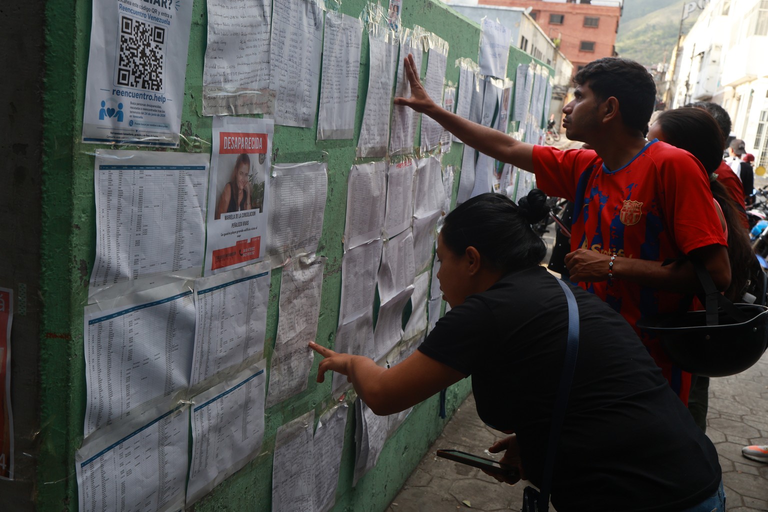 People searching for missing persons check lists three days after twin earthquakes struck La Guaira, Venezuela, Saturday, June 27, 2026. (AP Photo/Javier Campos)
Venezuela Earthquake