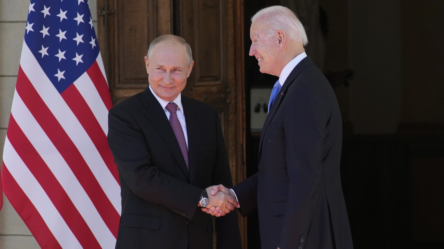 epa09275809 US President Joe Biden (R) and Russian President Vladimir Putin (L) shake hands during the US-Russia summit at the Villa La Grange, in Geneva, Switzerland, 16 June 2021. EPA/ALEXANDER ZEML ...