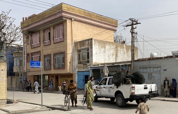 epa10514705 Taliban security personnel stand guard at the scene of a blast at a cultural center in Mazar-e-Sharif, provincial capital of Balkh province, Afghanistan, 11 March 2023. According to hospit ...