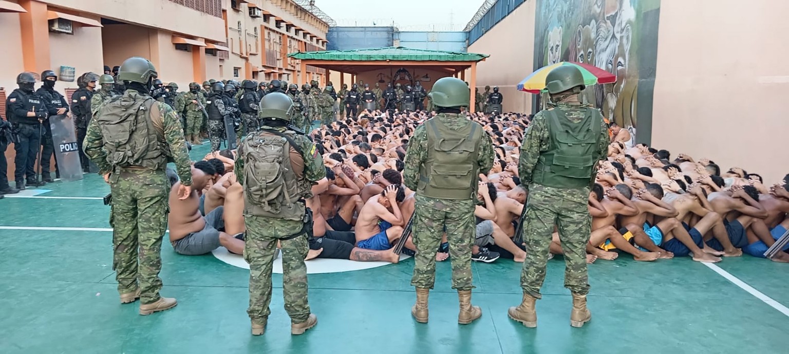 epa10783881 A handout photo made available by the Ecuadorian Armed Forces shows an intervention by law enforcement authorities in the Litoral Penitentiary in Guayaquil, Ecuador, 03 August 2023. During ...