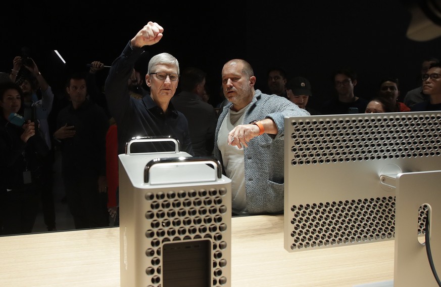 Apple CEO Tim Cook, left, and chief design officer Jonathan Ive look at a Mac Pro in the display room at the Apple Worldwide Developers Conference in San Jose, Calif., Monday, June 3, 2019. (AP Photo/ ...