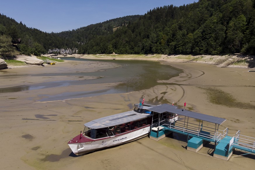 epa10077997 A picture taken with a drone shows a Navigation Boat on the Lake of Brenets (French: Navigation sur le lac des Brenets) trapped in the mud on the dried out shore of the Brenet Lake (French ...