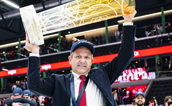 ZSC Lions&#039; Head coach Marco Bayer celebrates with the trophy of Swiss Champion after winning by 2:3 during the fifth leg of the National League Swiss Championship final playoff game between Lausa ...