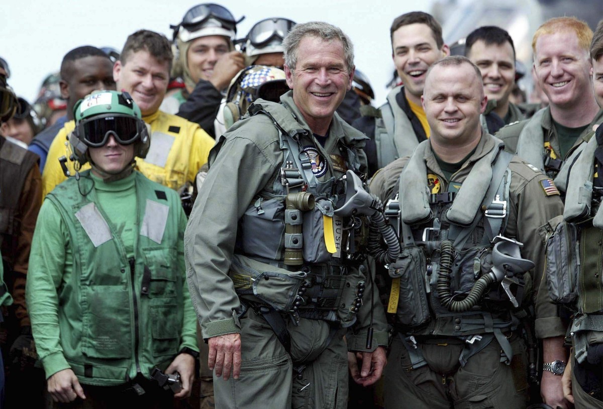 FILE - President George W. Bush poses with sailors and pilots aboard the USS Abraham Lincoln off the California coast after landing in a small jet May 1, 2003. (AP Photo/J. Scott Applewhite, File)
Tru ...