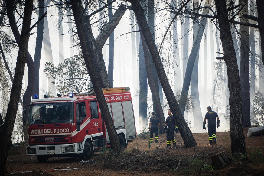 epa06081854 Italian fire fighters attend to fires burning near Vesuvius Volcano, outside Naples, Italy, 11 July 2017. A wildfire with a front stretching more than two kilometres raged on Vesuvius 11 J ...