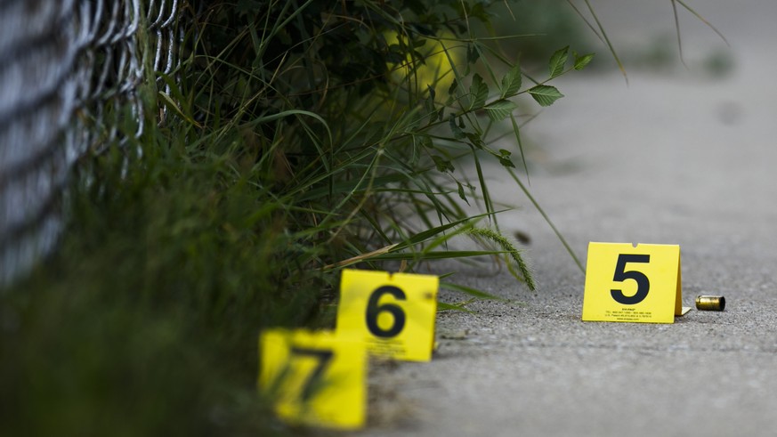 In this Sunday, Aug. 5, 2018 photo, evidence markers sit on the ground at the scene where a boy was killed after being shot in the abdomen while riding his bike in Chicago. Police Superintendent Eddie ...