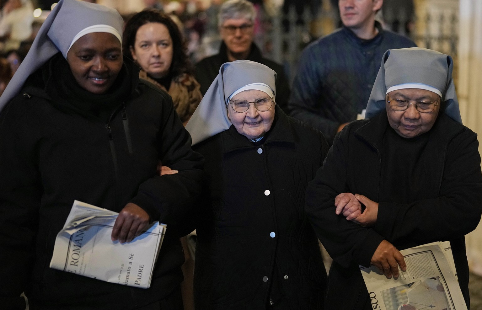 Nuns support each other as they leave after attending a rosary prayer outside the Santa Maria Maggiore Basilica, where the late Pope Francis will be buried, in Rome, Thursday, April 24, 2025. (AP Phot ...