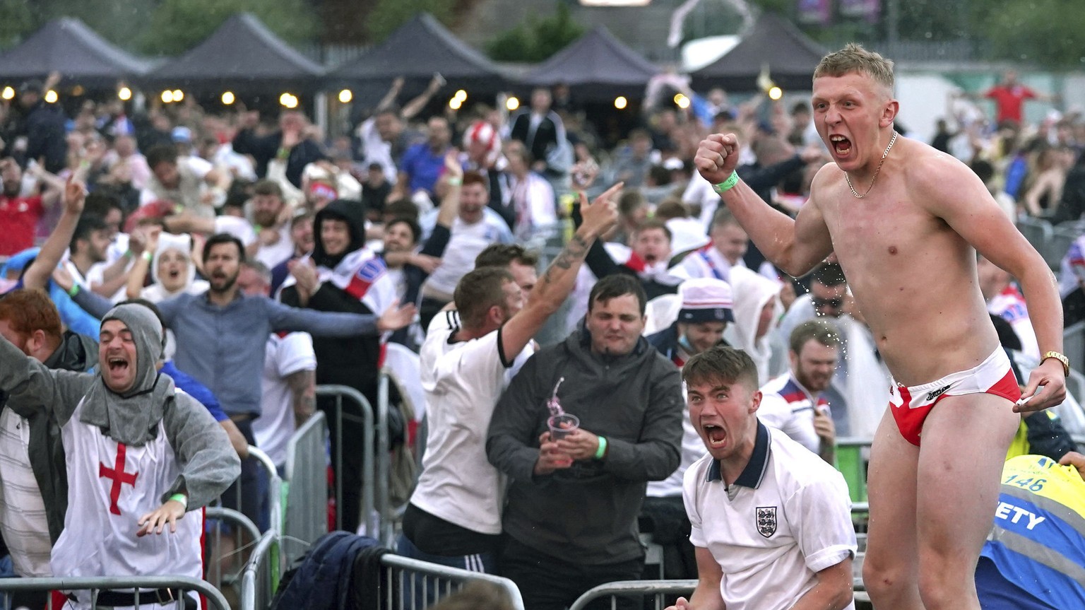 Fans react as Harry Maguire scores England&#039;s second goal, as they watch the Euro2020 soccer championship quarterfinal match between England and Ukraine, in Manchester, England, Saturda, July 3, 2 ...