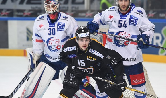 Zurich&#039;s goalkeeper Lukas Flueeler, Luganoâs player Gregory Hofmann and Zurich&#039;s player Christian Marti, from left, during the fifth match of the playoff final of the National League of th ...