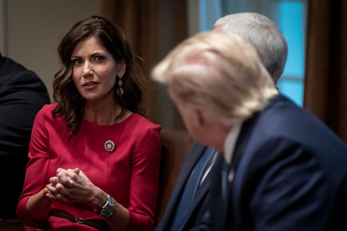WASHINGTON, DC - DECEMBER 16: (L-R) Governor of South Dakota Kristi Noem speaks as U.S. President Donald Trump listens during a meeting about the Governors Initiative on Regulatory Innovation in the C ...