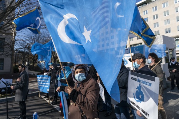 Members of the East Turkistan National Awakening Movement protest China&#039;s treatment of Uyghurs, during a protest near the State Department, Wednesday, Dec. 22, 2021, in Washington. (AP Photo/Alex ...