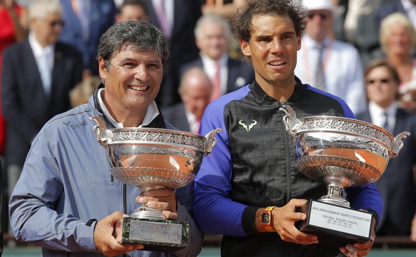 Spain's Rafael Nadal, right, poses with the special Decima cup while his oncle Toni Nadal holds the men's winner cup after the final match of the French Open tennis tournament at the Roland  ...